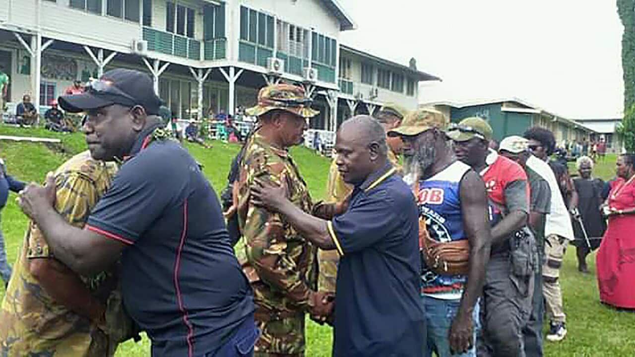 Former BRA fighters hugging PNG policemen at a Bougainville reconciliation ceremony ahead of the independence referendum