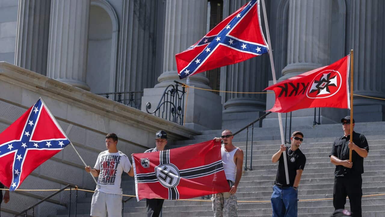 Members of white supremacists groups rally on the steps of the South Carolina Statehouse during New Black Panther Party and the Loyal White Knights of the Ku Klux Klan rallies on the grounds of the South Carolina Capitol in Columbia, South Carolina (AAP)
