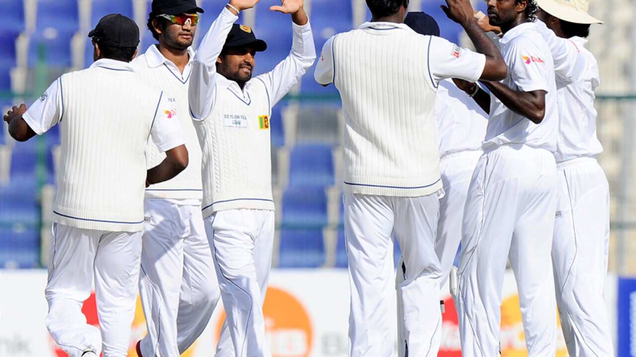 Sri Lankan cricketers celebrate after taking a wicket