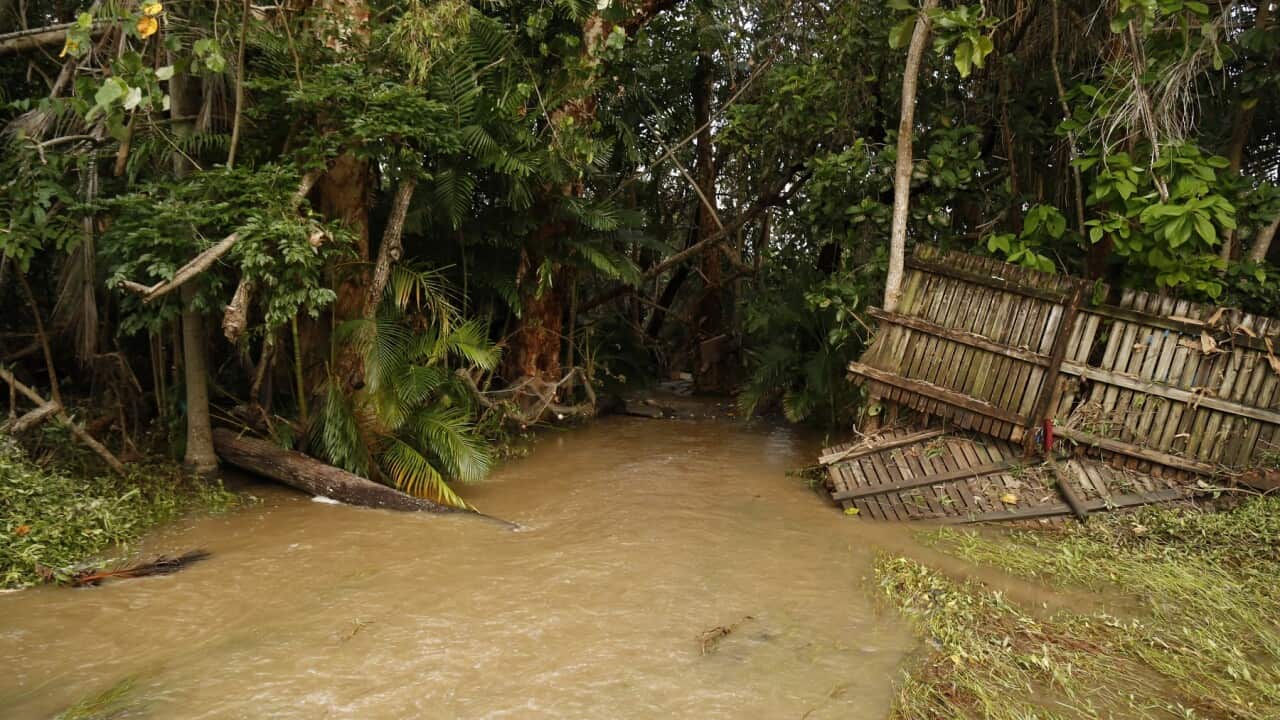 Masses of debris and fences have been strewn around the Cairns suburb of Holloways Beach after major flooding (AAP)