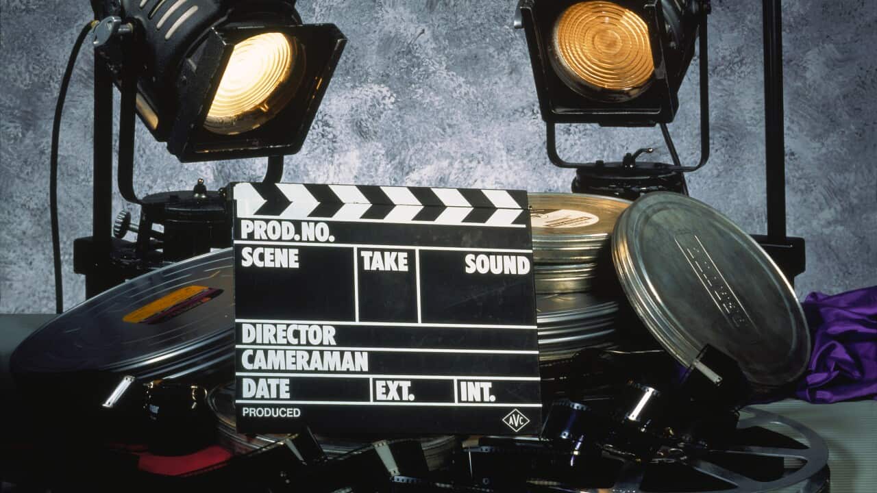 Clapperboard, film and two floodlights