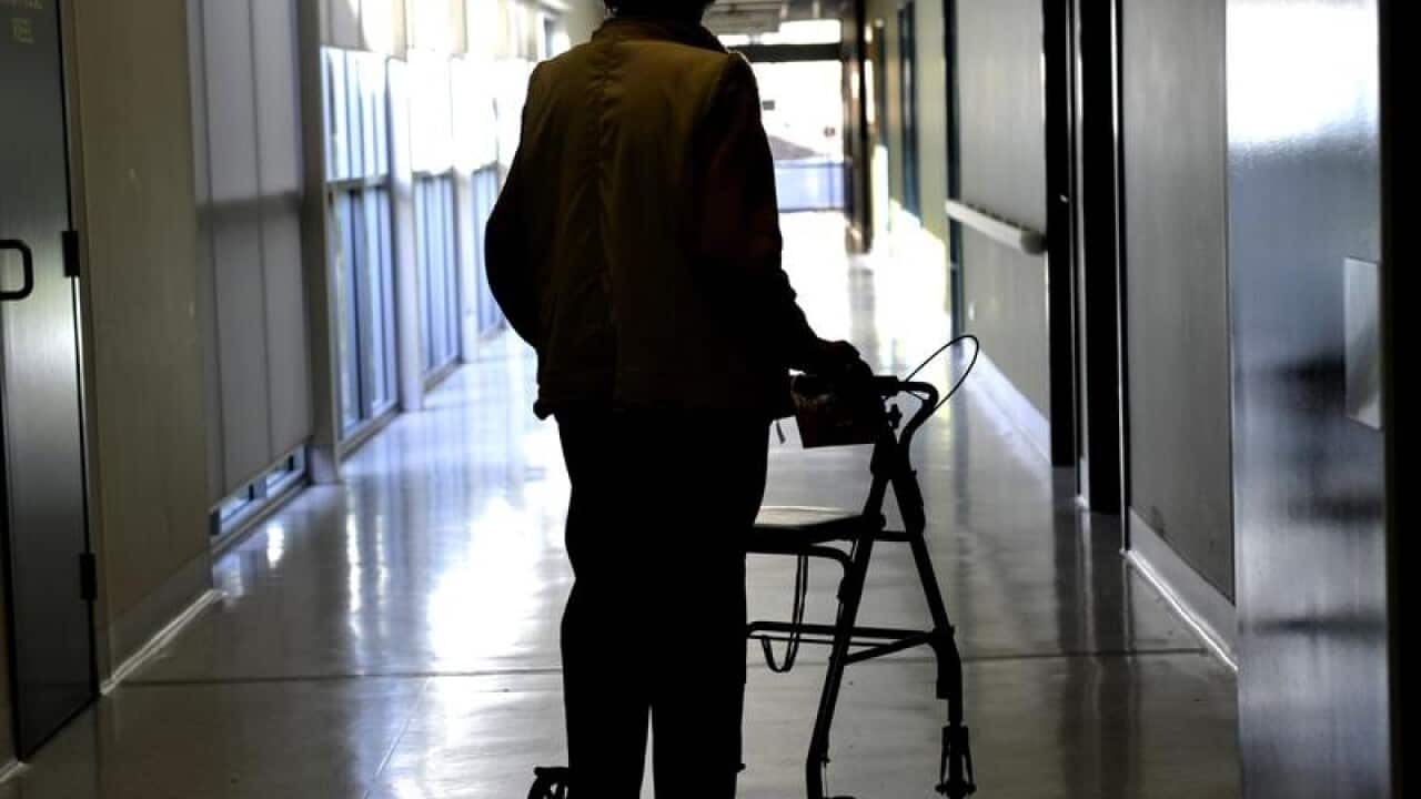A woman uses a mobility assistant