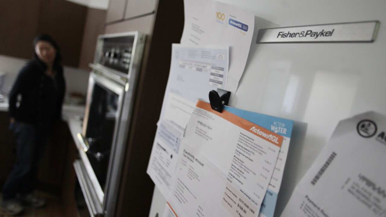Bills are seen on a fridge