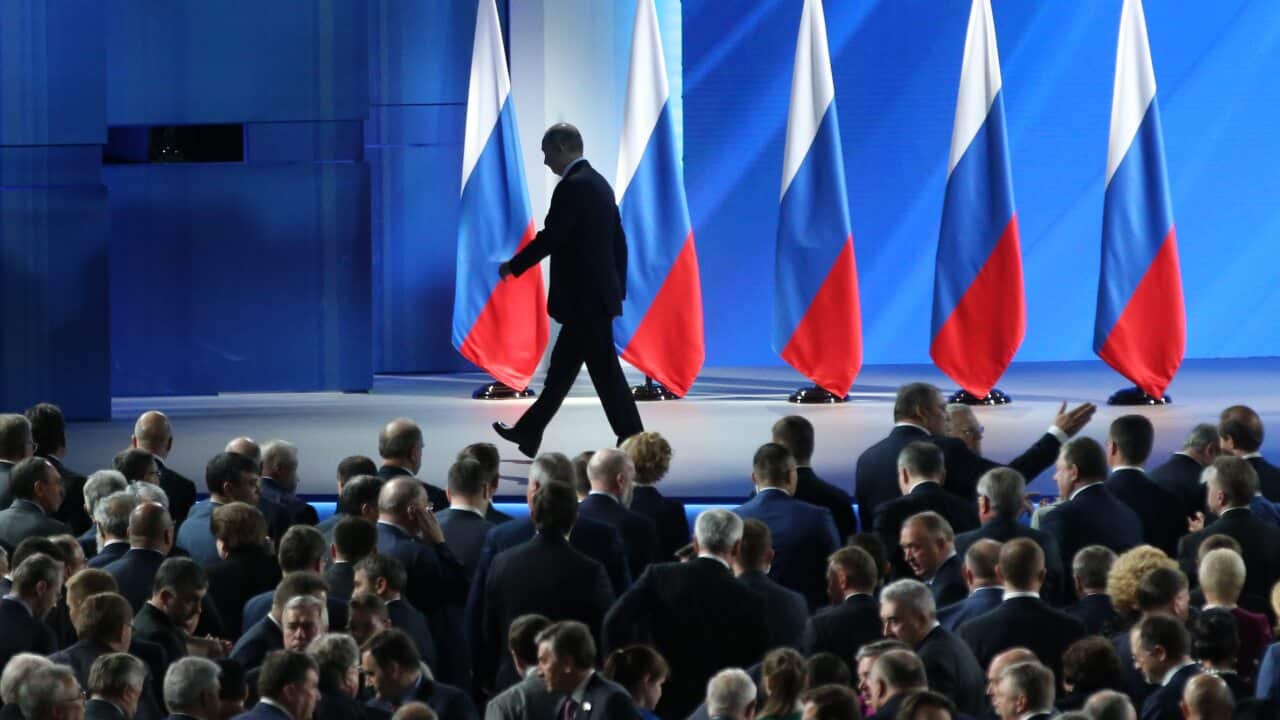 Mr Putin walks out following his national address.