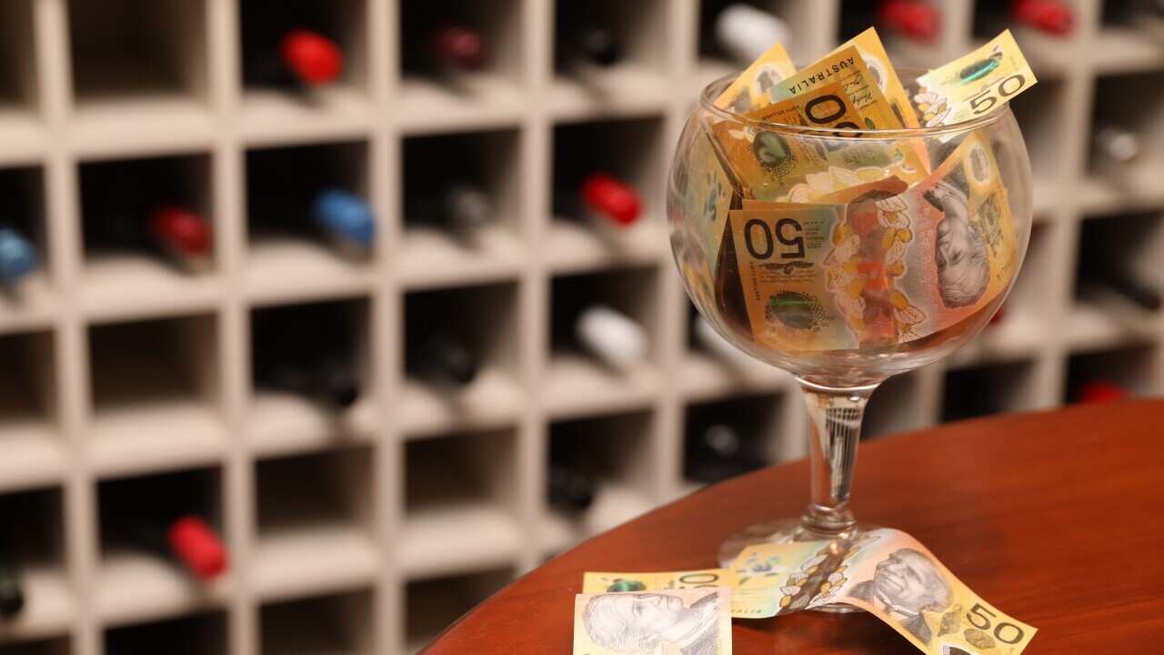 Commercial license
You're truly special, the one and only.
Congrats for a unique title
A wine glass filled with money in front of a wine rack