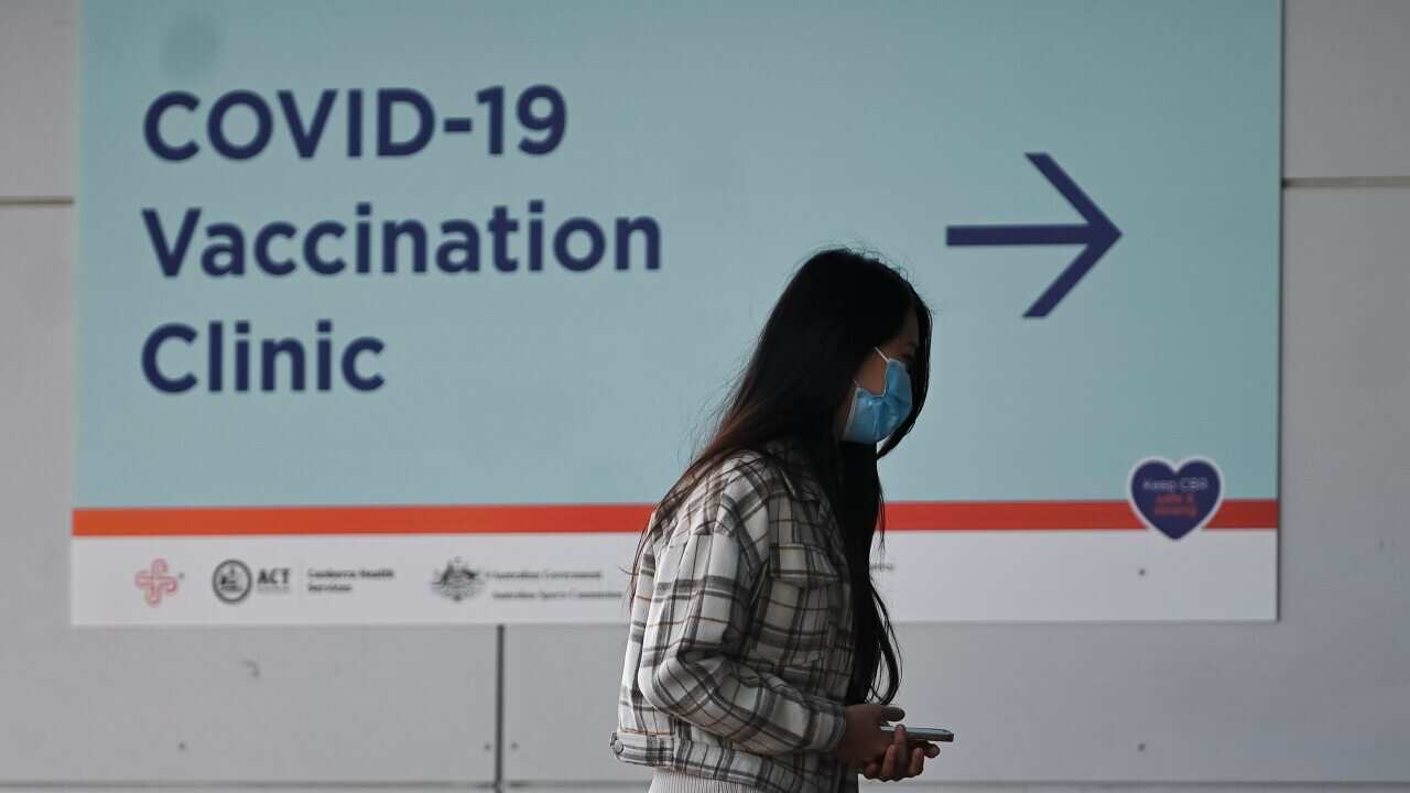 A woman waits outside the COVID-19 Vaccination Clinic at the Australian Institute of Sport in Canberra, Tuesday, September 14 2021
