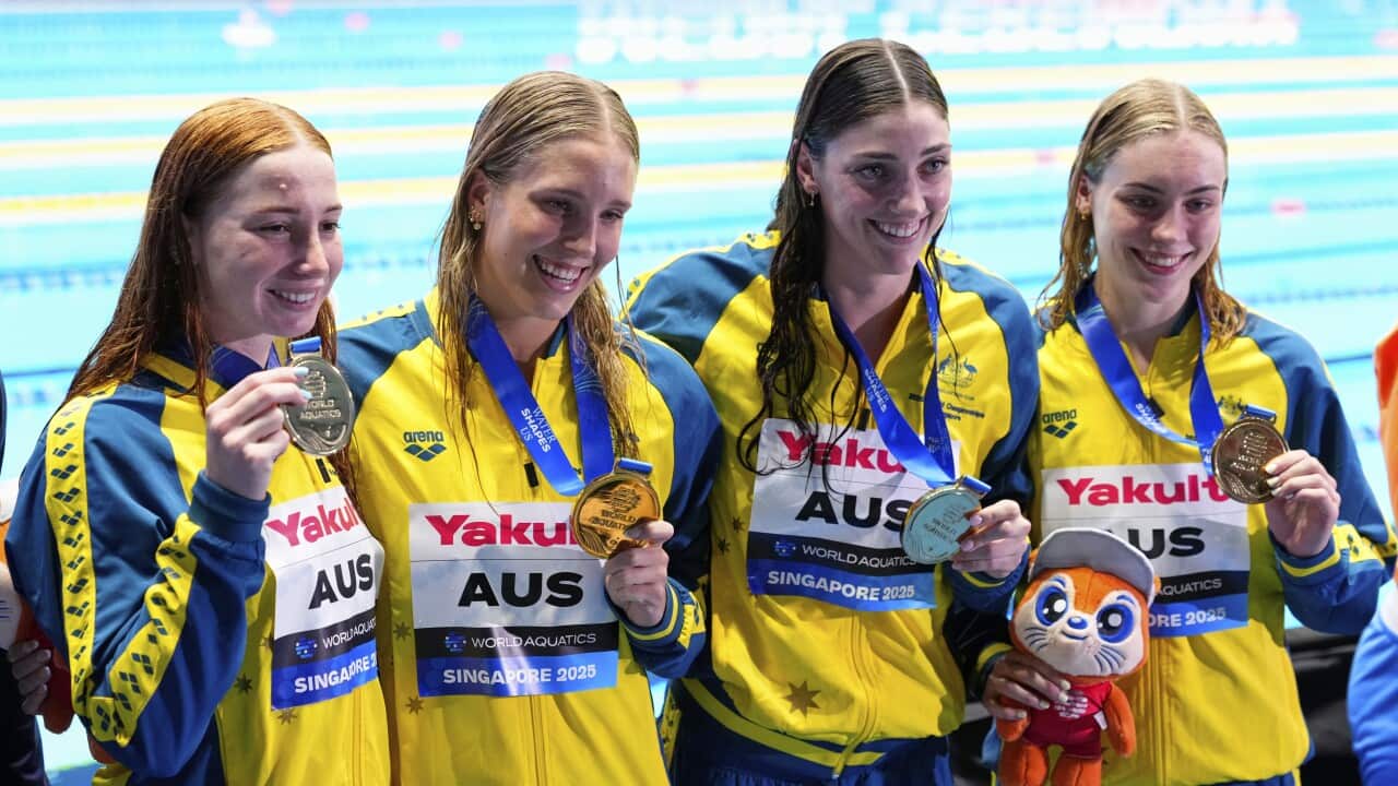 Gold medalist team Australia pose after the women's 4x100-meter freestyle final at the World Aquatics Championships in Singapore