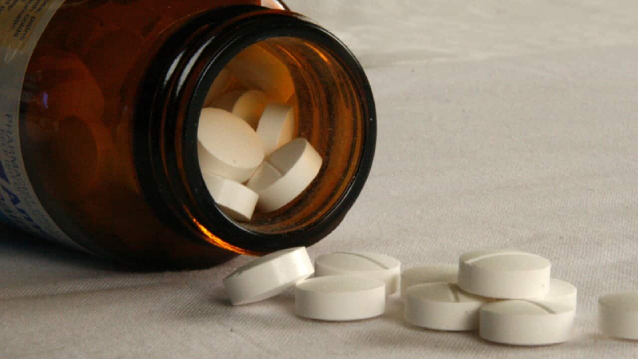 Pills fall from a jar