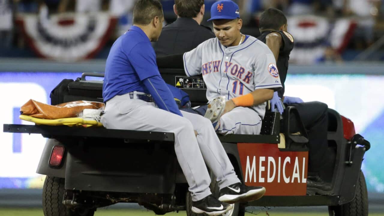 New York Mets shortstop Ruben Tejada is taken off the field