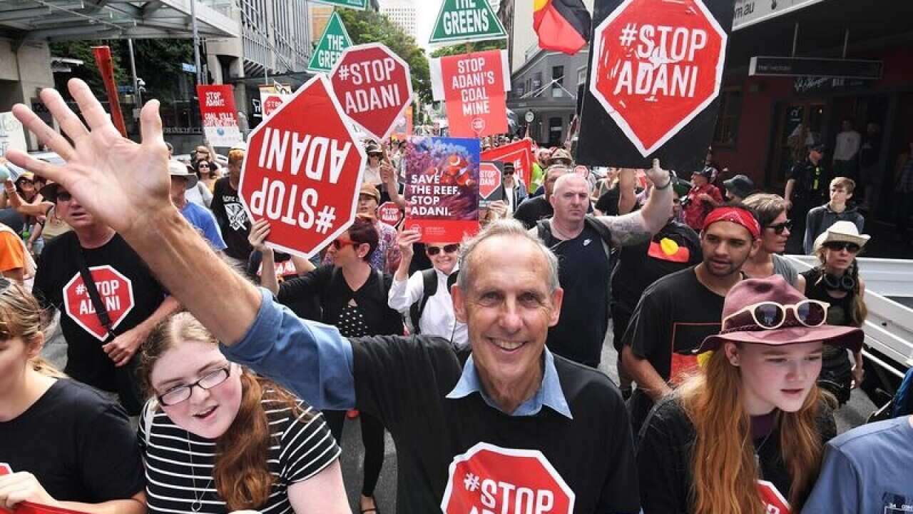 Conservationist Bob Brown leads a protest march through Brisbane.