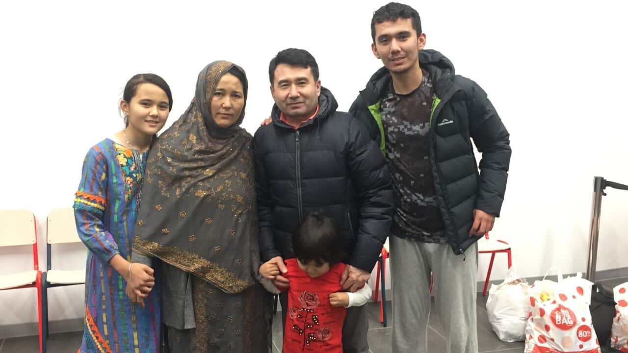 Three adults and two children standing together