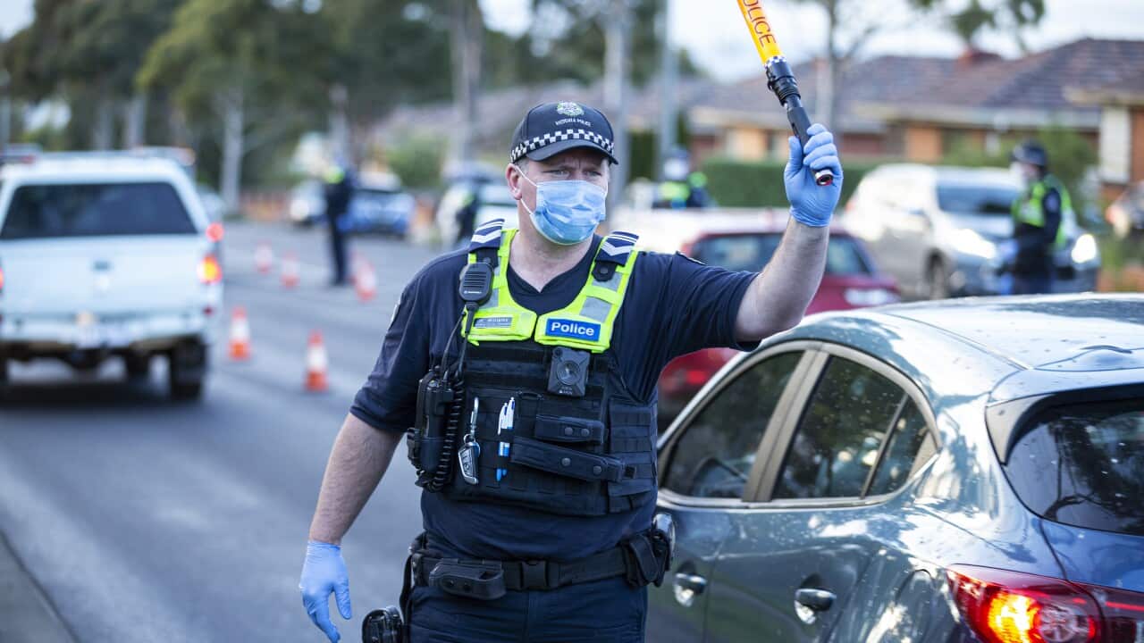 Police direct traffic at a suburban roadblock site in Broadmeadows, in Melbourne, Thursday, July 2, 2020. Suburbs in Victoria that have seen soaring cases of coronavirus will be locked down until July 29. (AAP Image/Daniel Pockett) NO ARCHIVING