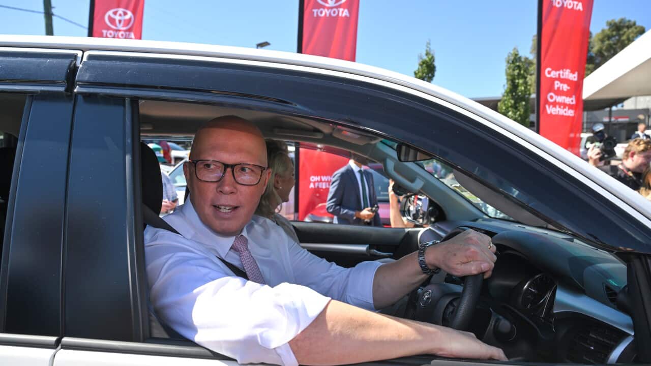 Opposition leader behind the wheel of his car on campaign trail.