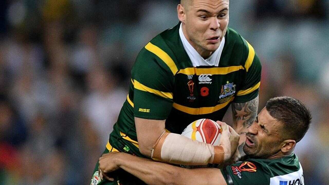 David Klemmer of Australia is tackled by Chris Saab of Lebanon