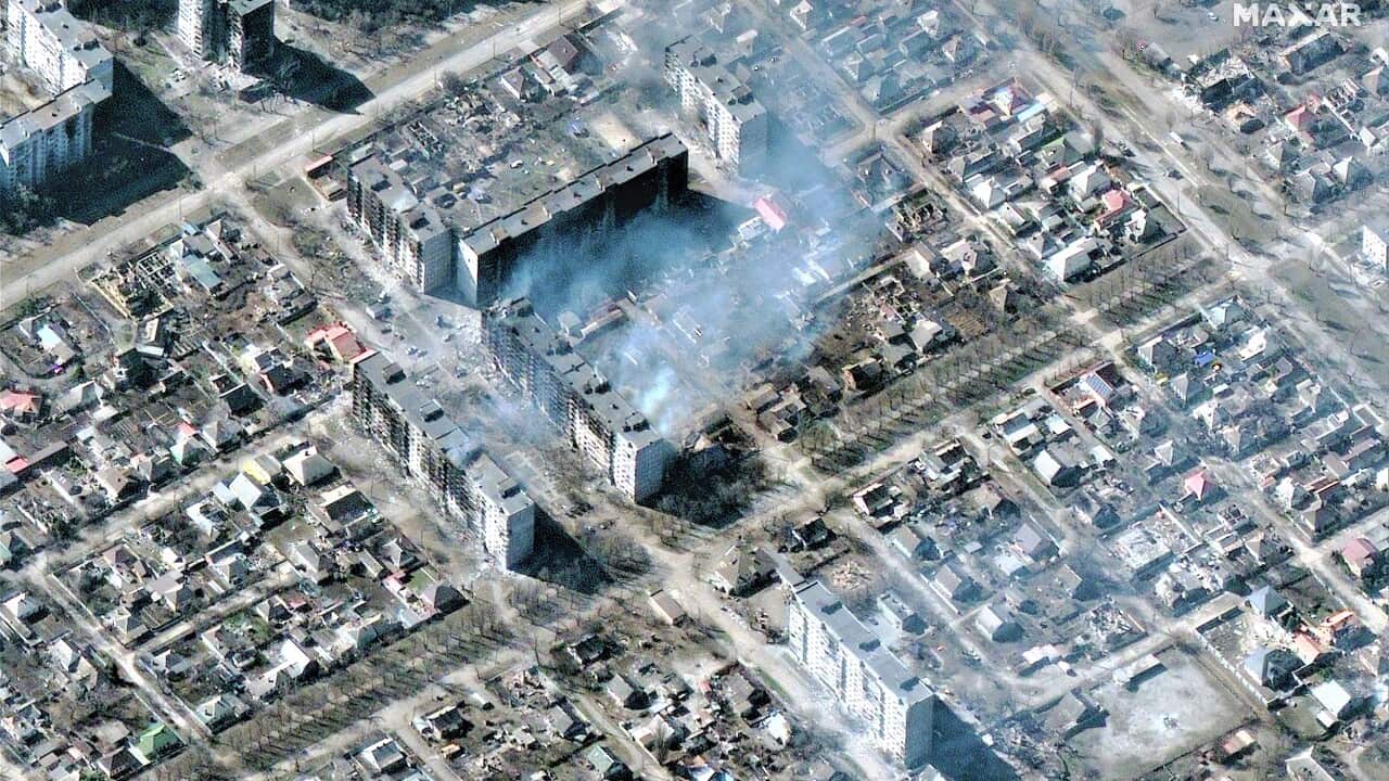 A handout satellite image made available by Maxar Technologies shows a burning high-rise apartment buildings in Mariupol, Ukraine, 22 March 2022.