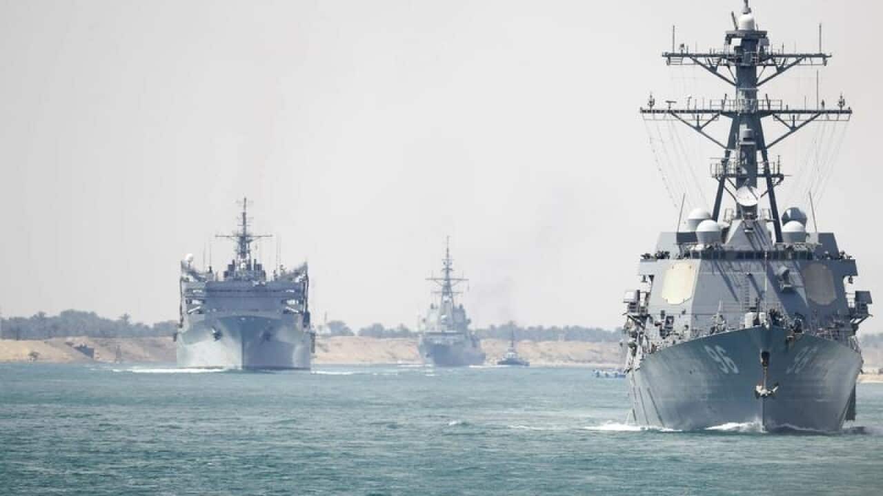 The carrier strike group transits through the Suez Canal
