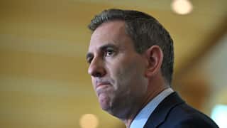 Jim Chalmers in a suit looking off to the side