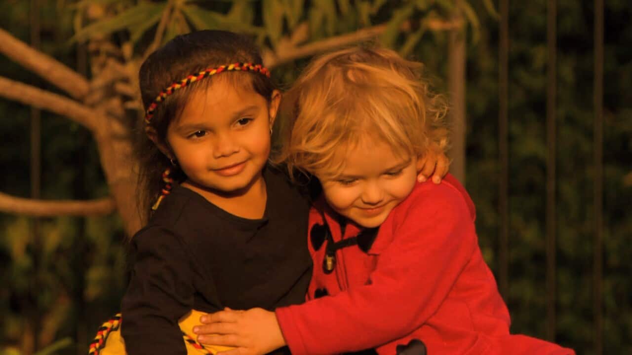 Three-year-old Samara Muir who recently experienced racism embraces her friend in Briggs' new single