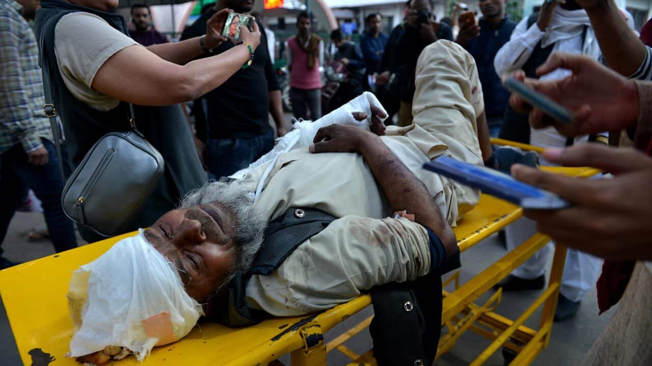 One of the injured is carried to the city hospital after riots broke out in eastern Delhi, New Delhi, India.