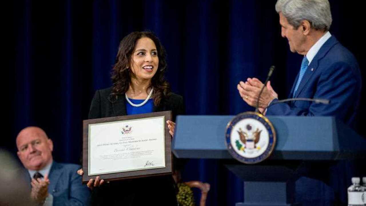 Secretary of State John Kerry applauds as Parosha Chandran of the United Kingdom, center, is recognized as a '2015 Trafficking in Persons Report hero' (AAP)