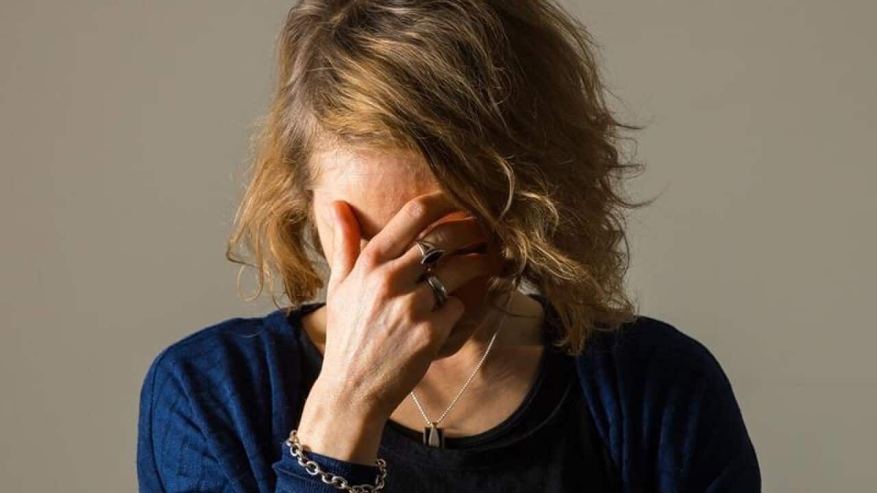 A file image of a model posing for an image showing signs of stress