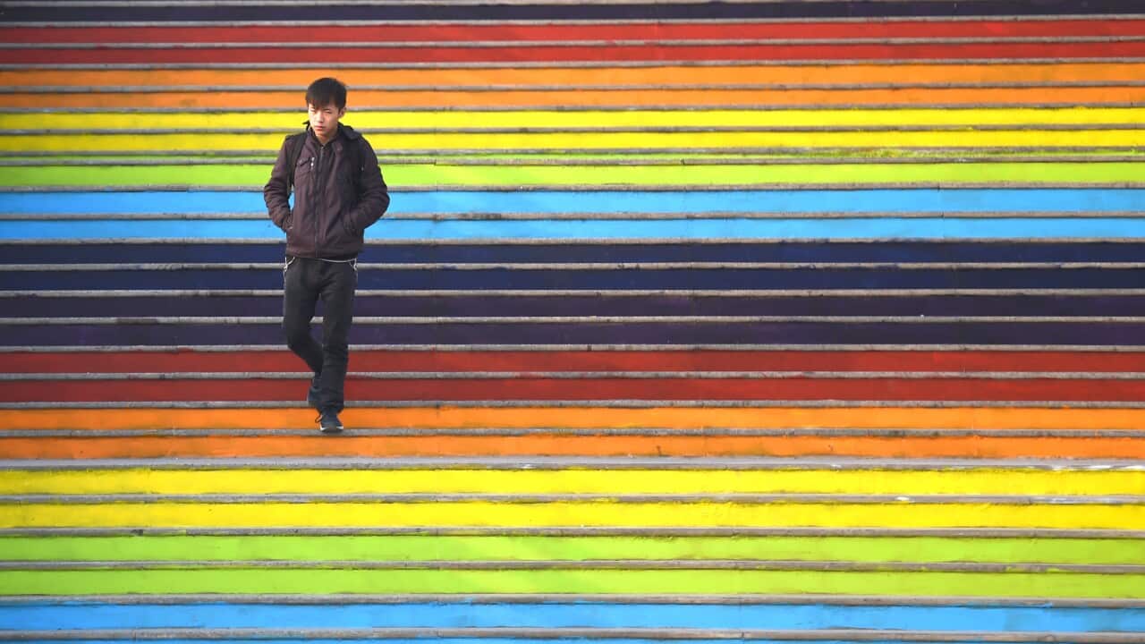 Man walks down rainbow steps 