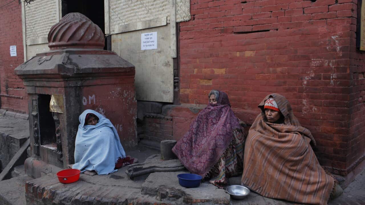 Nepalese women sit and wait for alms near Pashupatinath temple premises in Kathmandu