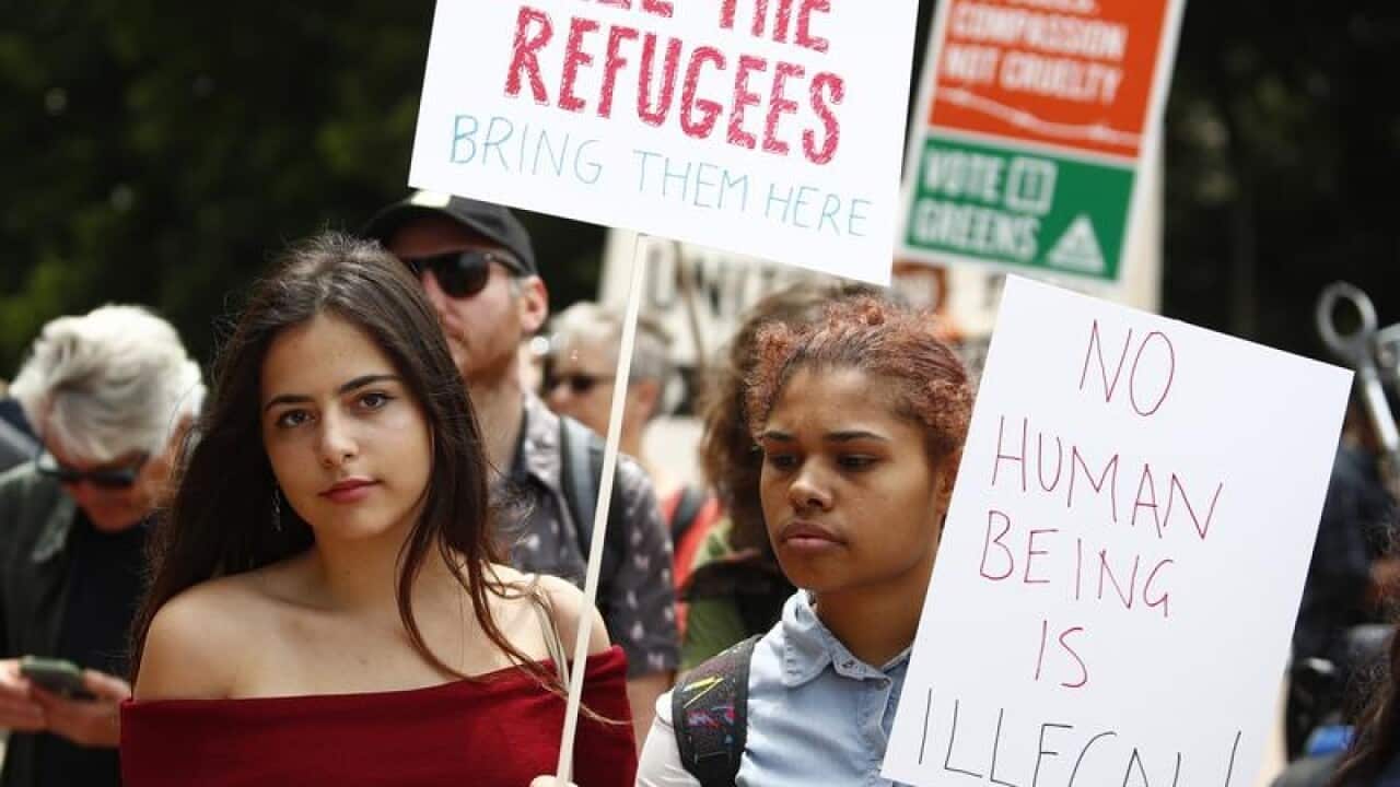 A file image of people attending a rally in support of refugees