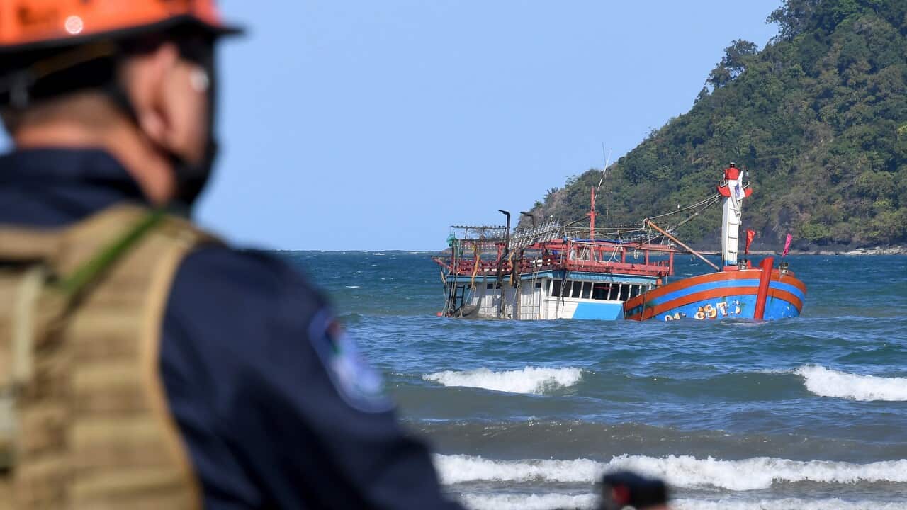 The sunken fishing boat lies off the beach at Cape Kimberly at the mouth of the Daintree River.