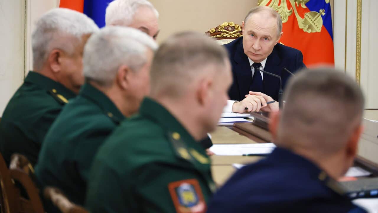 Vladimir Putin chairs a meeting of military generals.