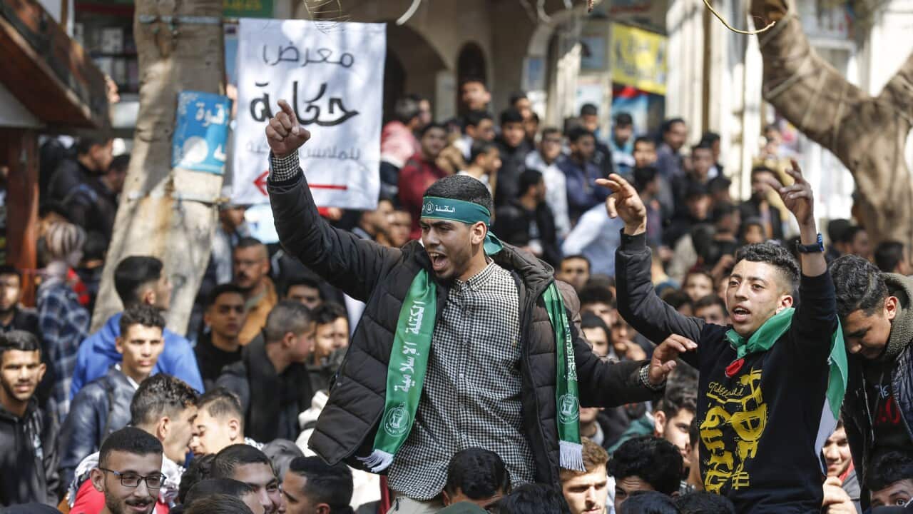 Palestinian youth chanting at a demonstration against a meeting in Jordan (AAP).jpg