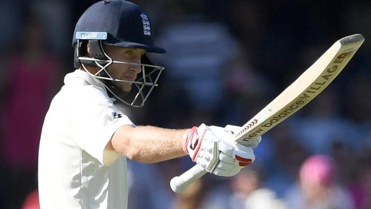 England captain Joe Root raises his bat after his half century