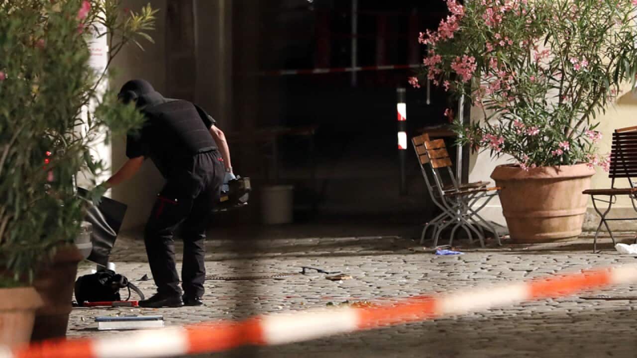 A special police officer examines a backpack in Ansbach