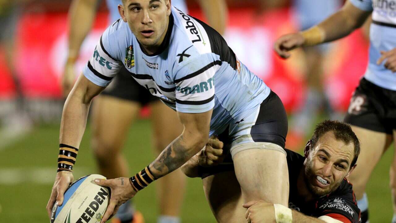 Cronulla's Jack Bird (left) is tackled by Warriors' Simon Mannering