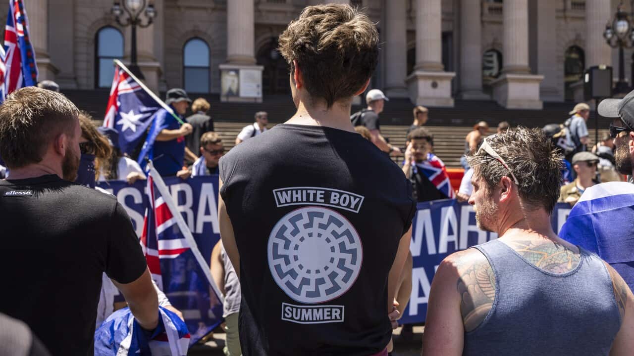 A protester seen wearing a shirt with a Sonnenrad (Black Sun
