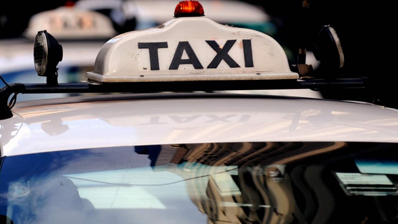 Taxis pass through the city of Sydney