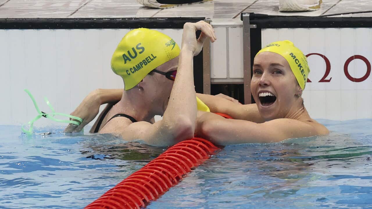 Australia's Emma McKeon (R) reacts after winning the Women's 100m Freestyle final at Tokyo Aquatics Centre in Tokyo.