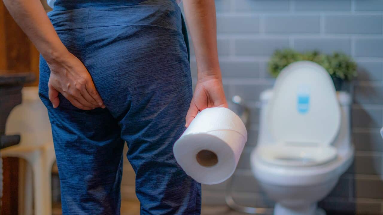 Woman using toilet and suffers from Diarrhea and Hemorrhoids after wake up at home in the morning