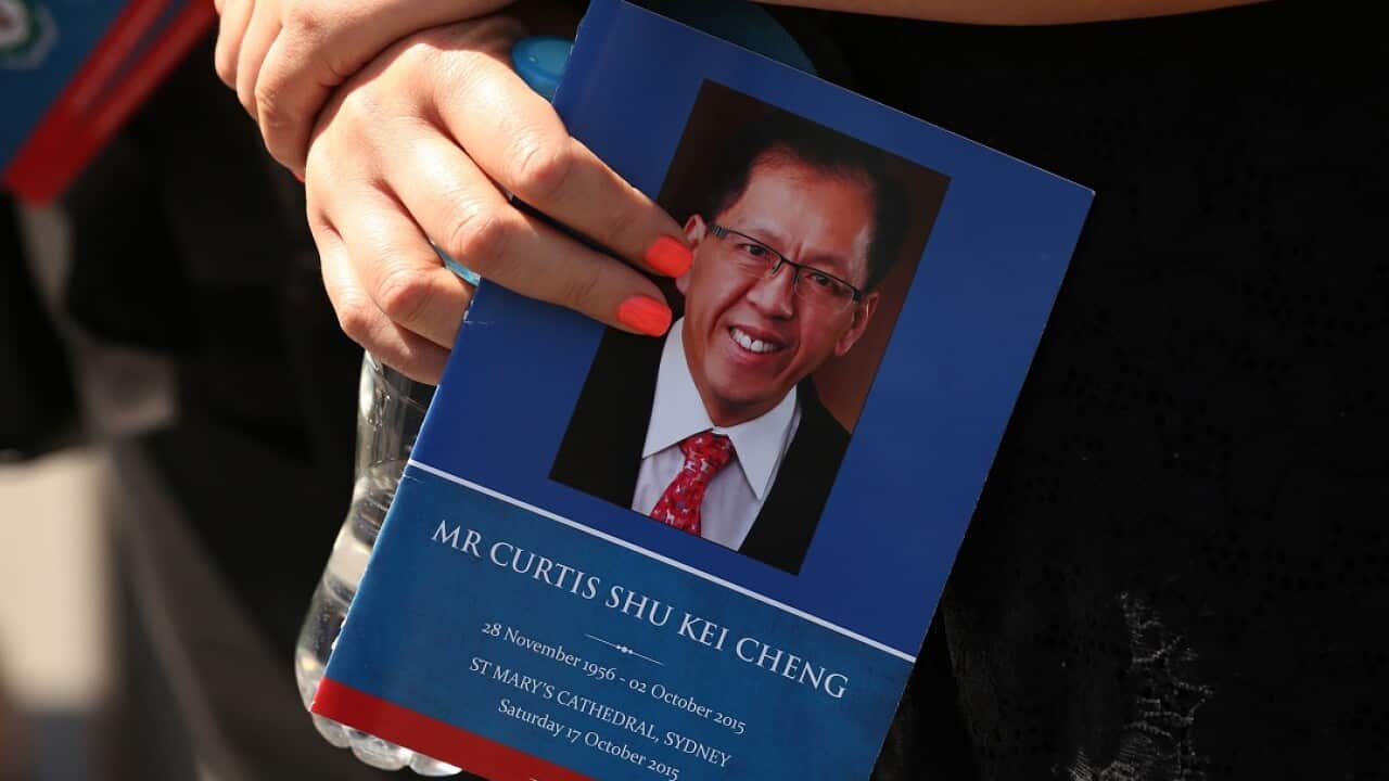 A woman holds an order of service for Curtis Cheng after his funeral service at St Mary's Cathedral, Sydney.