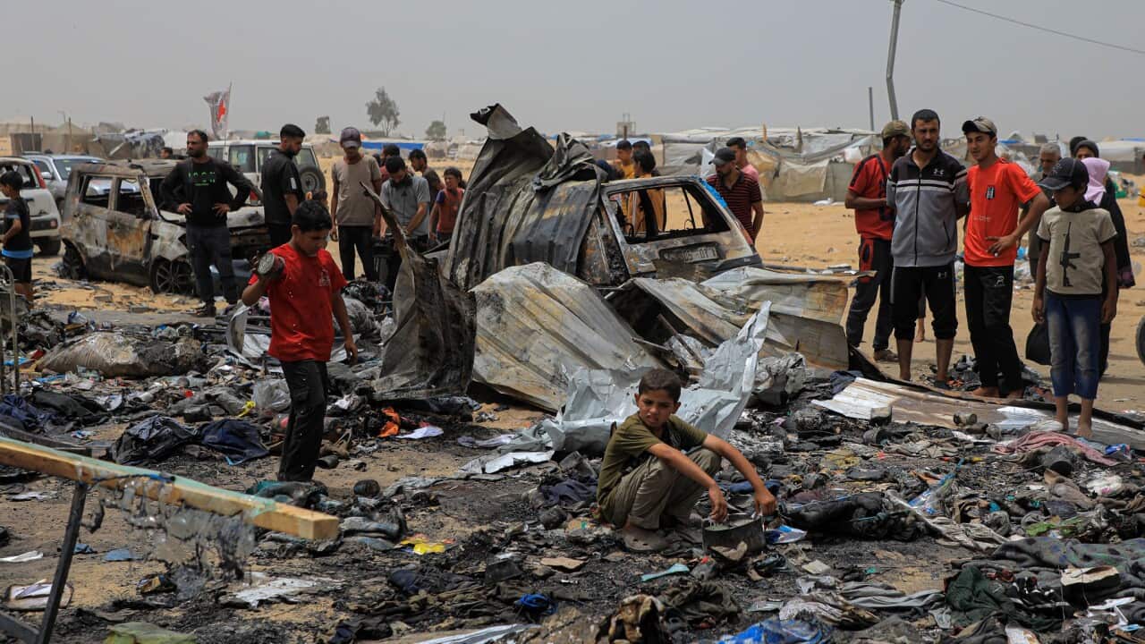 Palestinians at the site of the Israeli airstrike in Rafah (AAP)