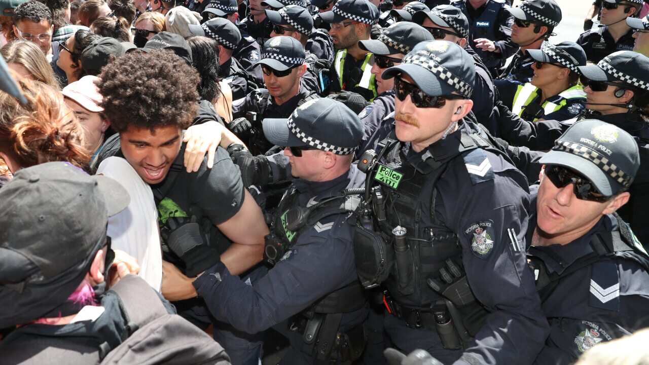 Protesters attempt to stop conference members entering during a protest against The International Mining and Resources Conference in Melbourne.