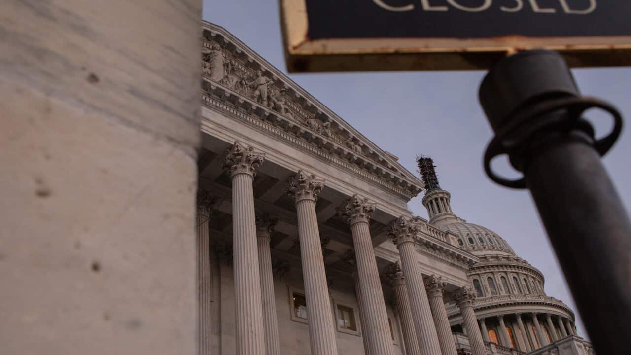 The US Capitol building with a “Closed” sign in the foreground.