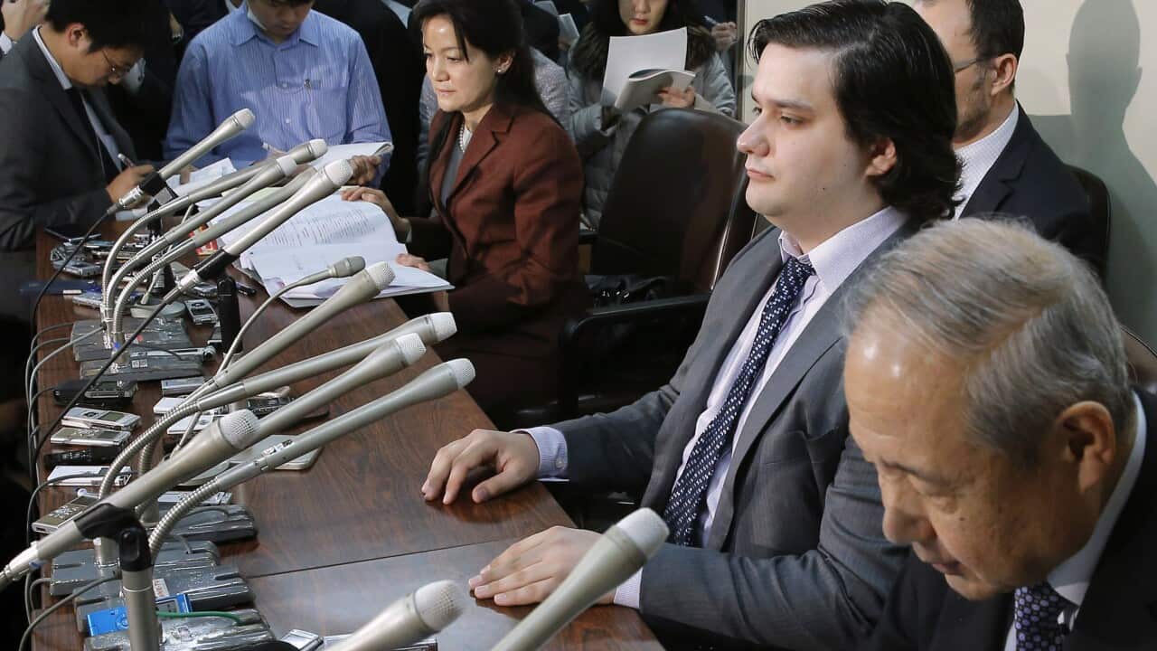file photo, Mt. Gox CEO Mark Karpeles, sitting at second right, attends a press conference at the Justice Ministry in Tokyo. 