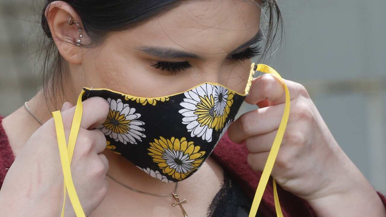 Anissa Archuleta, 23 wears her mask at her home in Midvale, Utah.