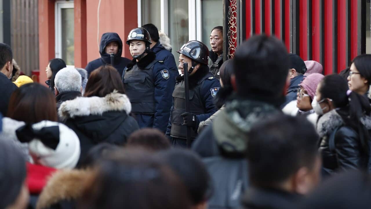 Two security guards in front of the school.