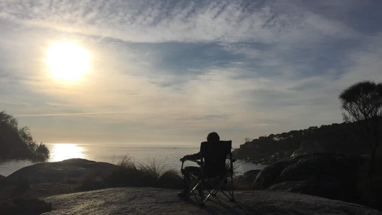 A person watching the sunset in Tasmania, Australia.
