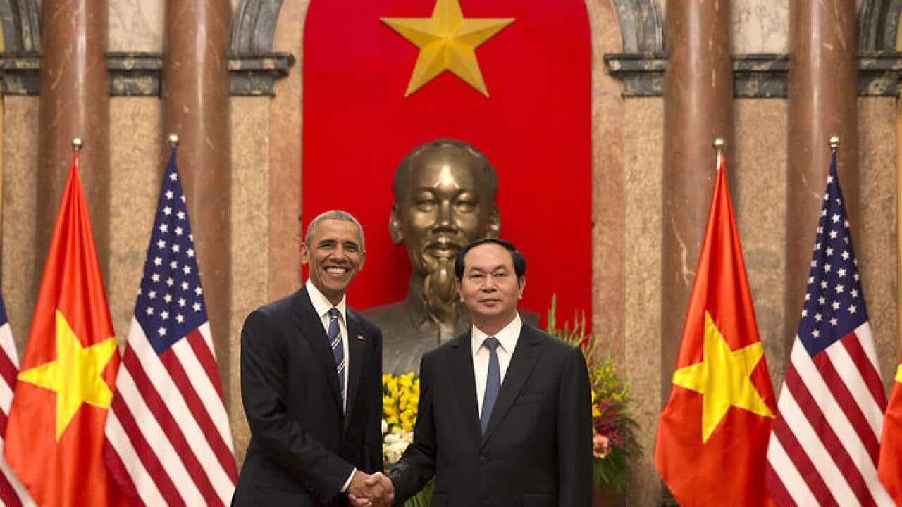  US President Barack Obama, left, and Vietnamese President Tran Dai Quang shake hands at the Presidential Palace in Hanoi (AAP) 