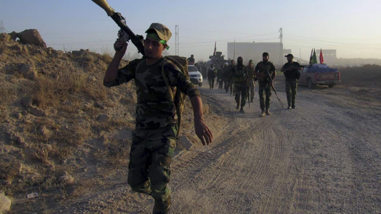 Iraqi security forces take combat positions outside in Fallujah