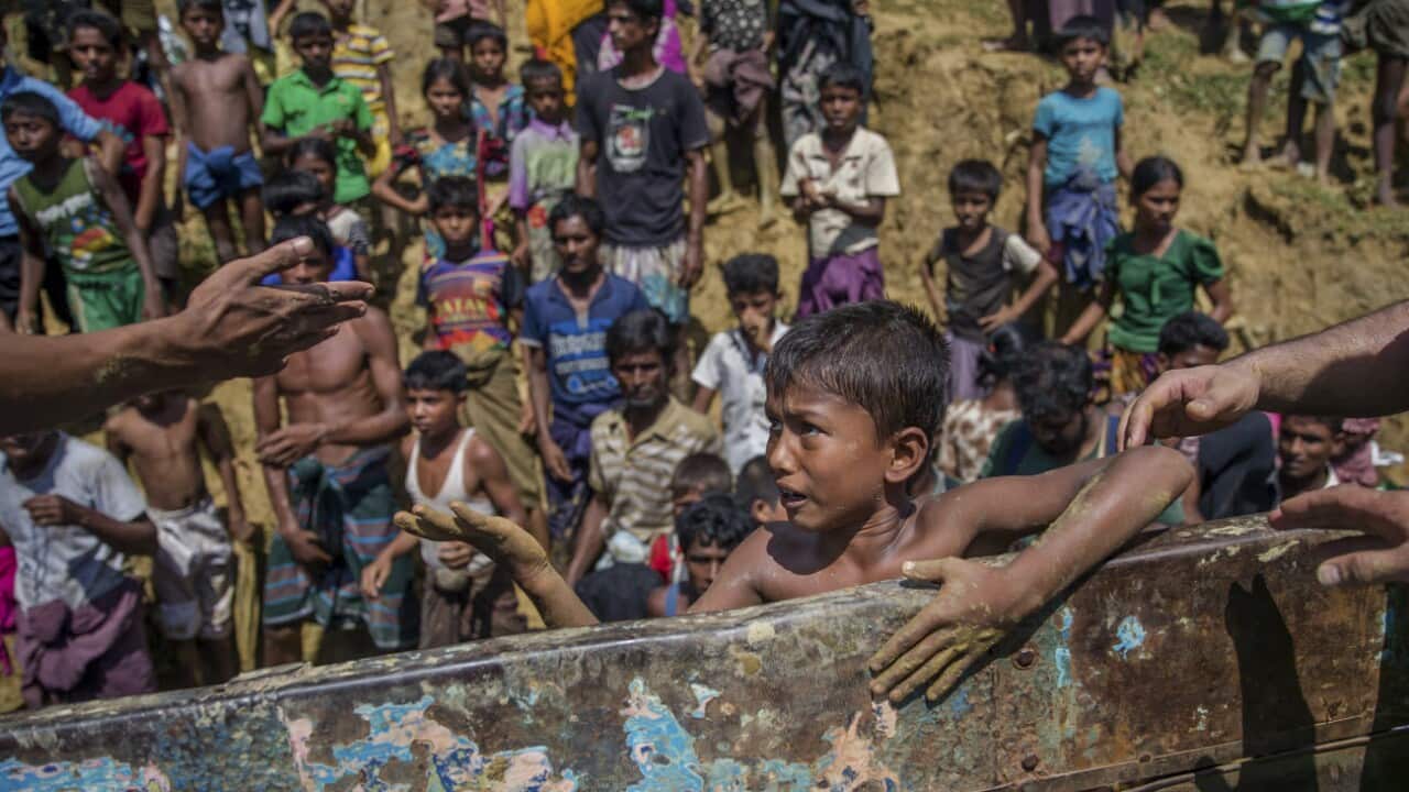 In this Sept. 21, 2017 photo, a Rohingya Muslim boy pleads for food near Balukhali refugee camp, Bangladesh.