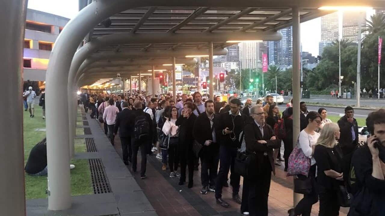 Commuters are seen queuing during train delays in Melbourne,